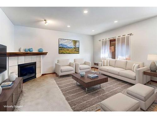 217 Elgin Manor Se, Calgary, AB - Indoor Photo Showing Living Room With Fireplace