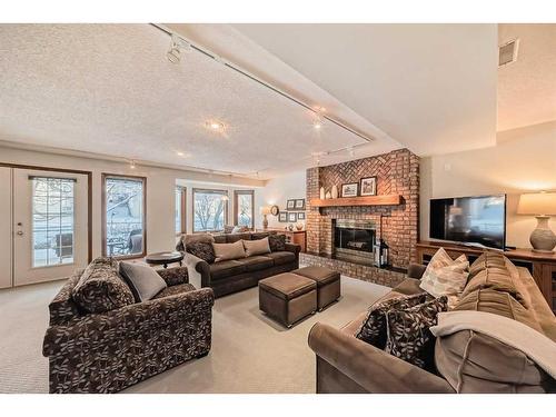 99 Hampshire Close Nw, Calgary, AB - Indoor Photo Showing Living Room With Fireplace