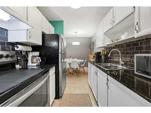 330-820 89 Avenue Sw, Calgary, AB - Indoor Photo Showing Kitchen With Stainless Steel Kitchen With Double Sink