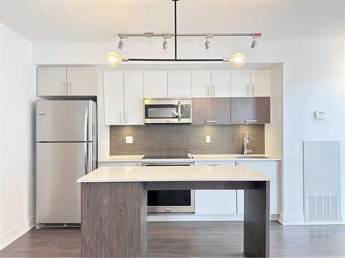 321-619 Confluence Way Se, Calgary, AB - Indoor Photo Showing Kitchen With Stainless Steel Kitchen With Upgraded Kitchen