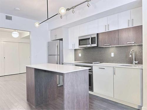 321-619 Confluence Way Se, Calgary, AB - Indoor Photo Showing Kitchen With Upgraded Kitchen