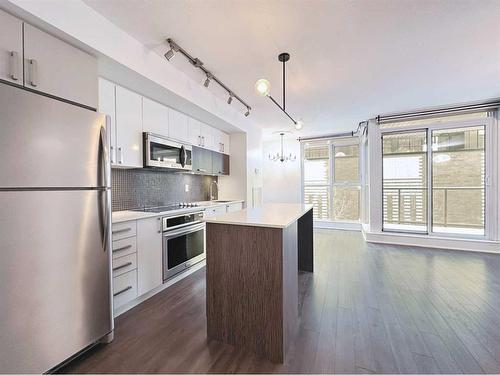 321-619 Confluence Way Se, Calgary, AB - Indoor Photo Showing Kitchen With Stainless Steel Kitchen With Upgraded Kitchen