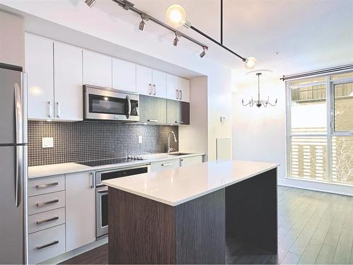 321-619 Confluence Way Se, Calgary, AB - Indoor Photo Showing Kitchen With Stainless Steel Kitchen With Upgraded Kitchen