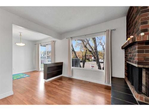 110 Hunterbrook Place Nw, Calgary, AB - Indoor Photo Showing Living Room With Fireplace