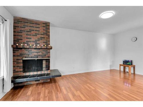 110 Hunterbrook Place Nw, Calgary, AB - Indoor Photo Showing Other Room With Fireplace