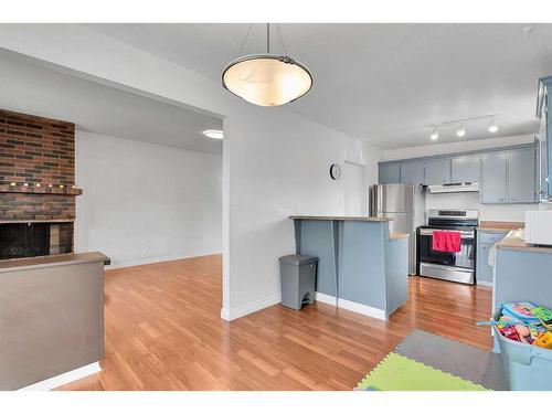 110 Hunterbrook Place Nw, Calgary, AB - Indoor Photo Showing Kitchen With Fireplace