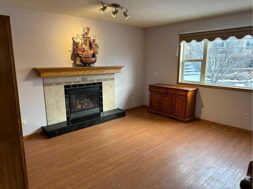 166 Cimarron Park Circle, Okotoks, AB - Indoor Photo Showing Living Room With Fireplace