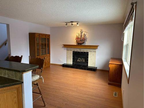 166 Cimarron Park Circle, Okotoks, AB - Indoor Photo Showing Living Room With Fireplace