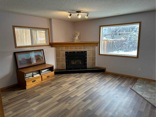 166 Cimarron Park Circle, Okotoks, AB - Indoor Photo Showing Living Room With Fireplace