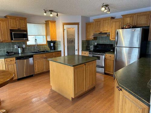 166 Cimarron Park Circle, Okotoks, AB - Indoor Photo Showing Kitchen With Double Sink