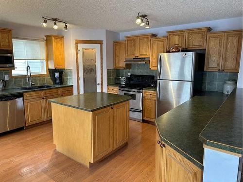 166 Cimarron Park Circle, Okotoks, AB - Indoor Photo Showing Kitchen With Double Sink