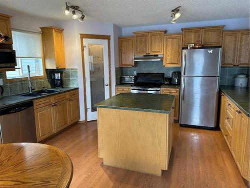 166 Cimarron Park Circle, Okotoks, AB - Indoor Photo Showing Kitchen With Double Sink