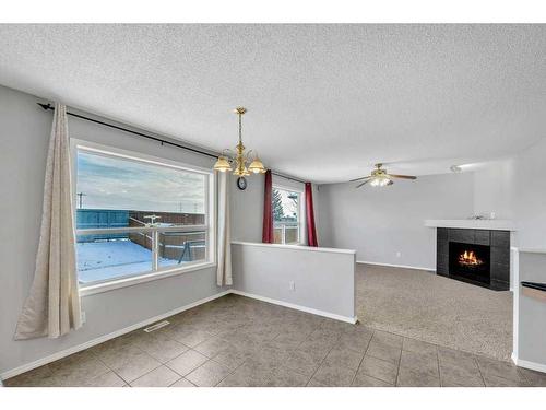 256 Oakmere Place, Chestermere, AB - Indoor With Fireplace