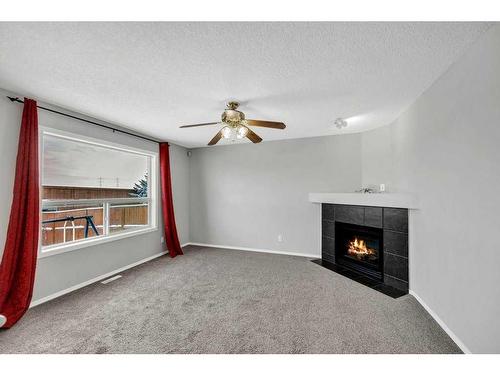 256 Oakmere Place, Chestermere, AB - Indoor Photo Showing Other Room With Fireplace