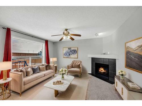 256 Oakmere Place, Chestermere, AB - Indoor Photo Showing Living Room With Fireplace