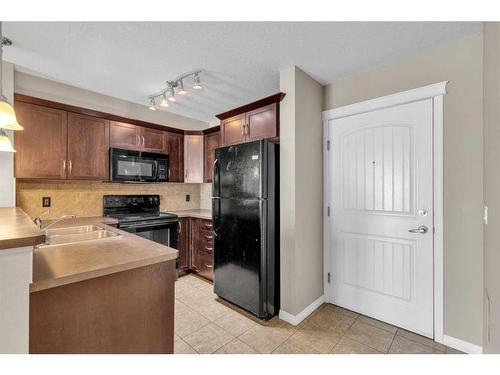 1310-175 Panatella Hill Nw, Calgary, AB - Indoor Photo Showing Kitchen With Double Sink