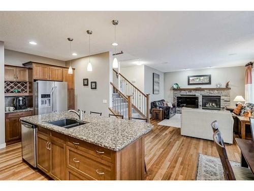 70 Valley Crest Rise Nw, Calgary, AB - Indoor Photo Showing Kitchen With Fireplace With Double Sink