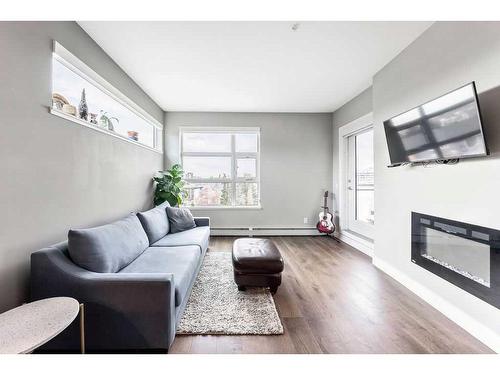 306-515 4 Avenue Ne, Calgary, AB - Indoor Photo Showing Living Room With Fireplace