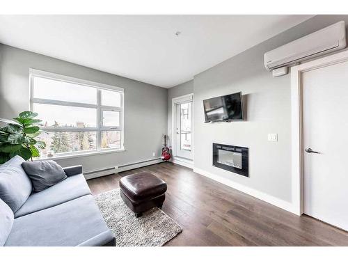 306-515 4 Avenue Ne, Calgary, AB - Indoor Photo Showing Living Room With Fireplace