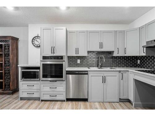 2108-12 Cimarron Common, Okotoks, AB - Indoor Photo Showing Kitchen With Double Sink