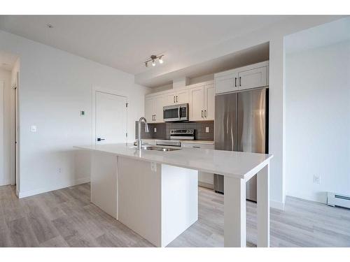 5104-200 Seton Circle Se, Calgary, AB - Indoor Photo Showing Kitchen With Stainless Steel Kitchen With Double Sink