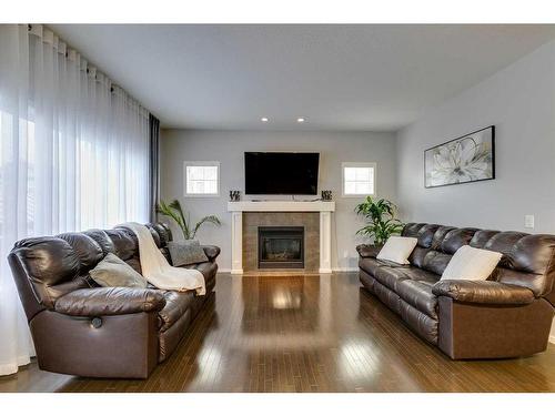 125 Copperstone Close Se, Calgary, AB - Indoor Photo Showing Living Room With Fireplace