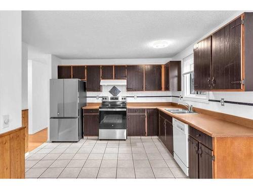 207 Fallswater Road Ne, Calgary, AB - Indoor Photo Showing Kitchen With Double Sink