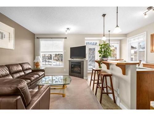 235 Rockyspring Grove Nw, Calgary, AB - Indoor Photo Showing Living Room With Fireplace