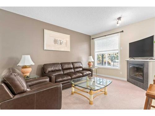 235 Rockyspring Grove Nw, Calgary, AB - Indoor Photo Showing Living Room With Fireplace