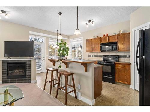 235 Rockyspring Grove Nw, Calgary, AB - Indoor Photo Showing Kitchen With Fireplace