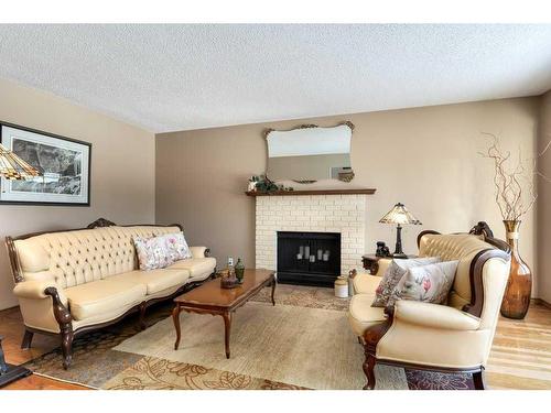 16 Cedardale Rise Sw, Calgary, AB - Indoor Photo Showing Living Room With Fireplace