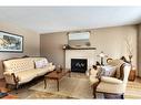 16 Cedardale Rise Sw, Calgary, AB  - Indoor Photo Showing Living Room With Fireplace 