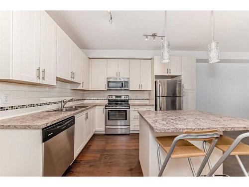 1408-755 Copperpond Boulevard Se, Calgary, AB - Indoor Photo Showing Kitchen With Stainless Steel Kitchen With Double Sink With Upgraded Kitchen