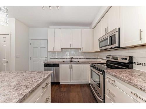 1408-755 Copperpond Boulevard Se, Calgary, AB - Indoor Photo Showing Kitchen With Stainless Steel Kitchen With Double Sink