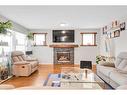 94 Everridge Court Sw, Calgary, AB  - Indoor Photo Showing Living Room With Fireplace 