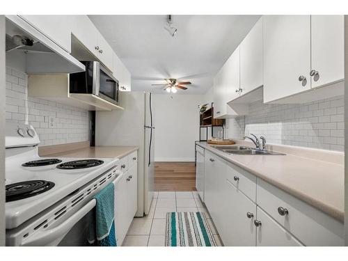 18B-80 Galbraith Drive Sw, Calgary, AB - Indoor Photo Showing Kitchen With Double Sink