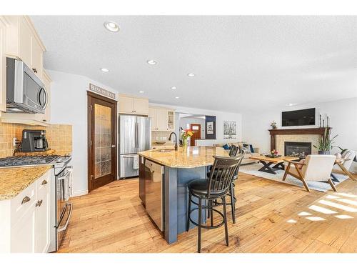 7 Jumping Pound Terrace, Cochrane, AB - Indoor Photo Showing Kitchen With Fireplace With Upgraded Kitchen