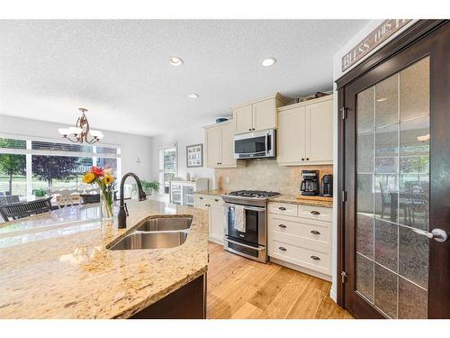 7 Jumping Pound Terrace, Cochrane, AB - Indoor Photo Showing Kitchen With Double Sink With Upgraded Kitchen