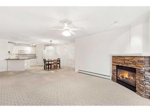 1201-7451 Springbank Boulevard Sw, Calgary, AB - Indoor Photo Showing Living Room With Fireplace