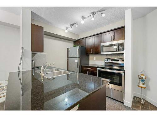 2417-81 Legacy Boulevard Se, Calgary, AB - Indoor Photo Showing Kitchen With Stainless Steel Kitchen With Double Sink