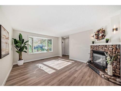 3420 Button Road Nw, Calgary, AB - Indoor Photo Showing Living Room With Fireplace