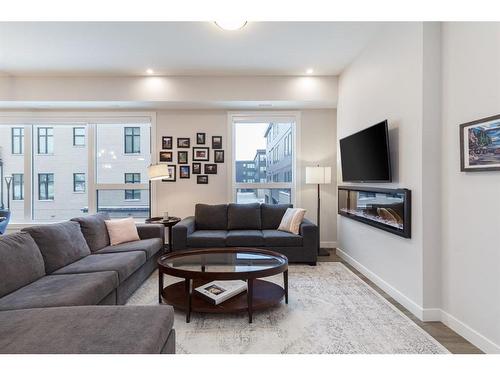 202-235 Lebel Crescent Nw, Calgary, AB - Indoor Photo Showing Living Room With Fireplace