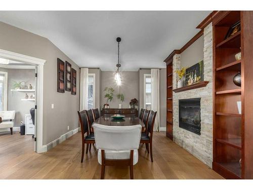 138 Aspen Stone Grove Sw, Calgary, AB - Indoor Photo Showing Dining Room With Fireplace