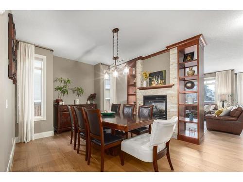 138 Aspen Stone Grove Sw, Calgary, AB - Indoor Photo Showing Dining Room With Fireplace