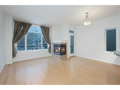 201-824 10 Street Nw, Calgary, AB - Indoor Photo Showing Living Room With Fireplace