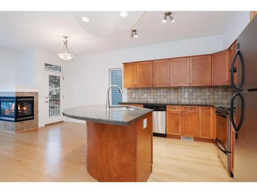 201-824 10 Street Nw, Calgary, AB - Indoor Photo Showing Kitchen With Fireplace With Double Sink