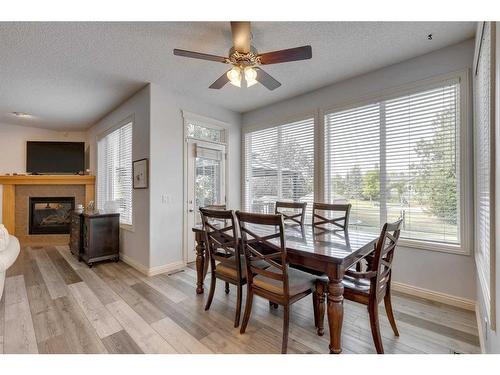 113 Cranleigh Bay Se, Calgary, AB - Indoor Photo Showing Dining Room With Fireplace