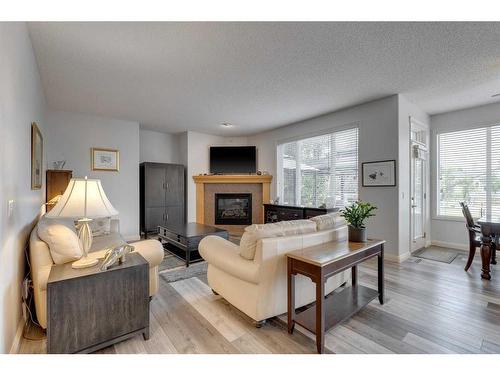 113 Cranleigh Bay Se, Calgary, AB - Indoor Photo Showing Living Room With Fireplace