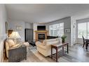 113 Cranleigh Bay Se, Calgary, AB  - Indoor Photo Showing Living Room With Fireplace 