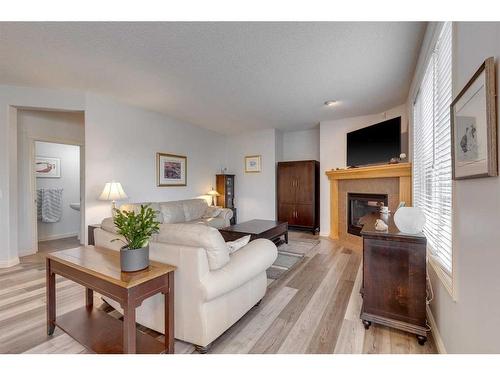 113 Cranleigh Bay Se, Calgary, AB - Indoor Photo Showing Living Room With Fireplace